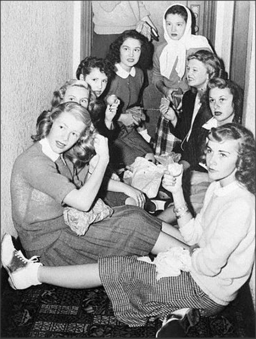 Bobby Soxers crowd in a hotel hallway waiting to catch a glimpse of Errol Flynn, 1945Alameda, Califo