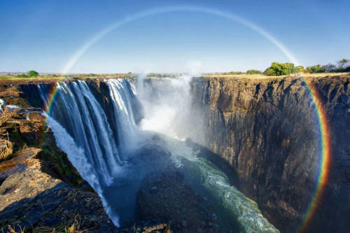 sixpenceee:  Victoria Falls lies on the border of Zambia and Zimbabwe. It’s the largest waterfall in the world. 