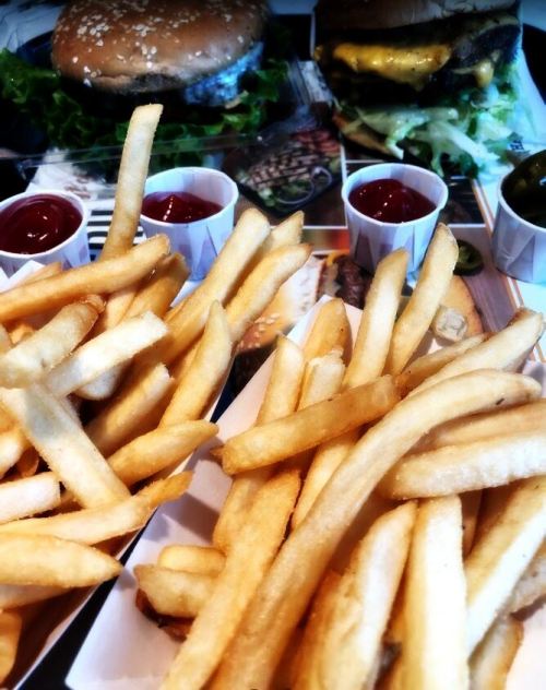 Cheeseburgers and french fries with ketchup