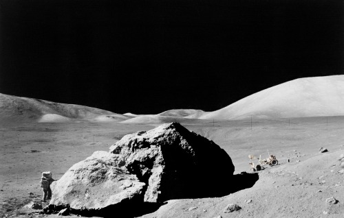 spaceexp:Scientist-astronaut Harrison H. Schmitt standing next to a huge, split lunar boulder during