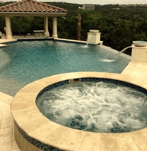 Mid-sized Tuscan Backyard Stone And Custom-shaped Infinity Hot Tub Photo