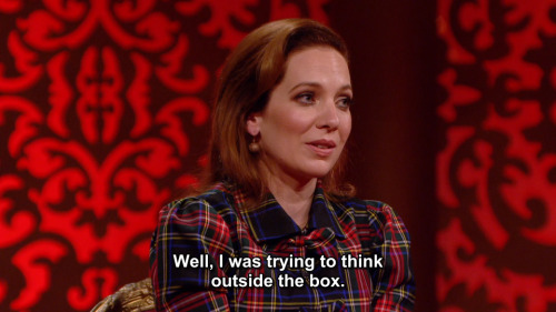 [ID: Five screencaps from Taskmaster. Katherine Parkinson stands in a white room, in front of a tabl