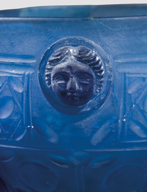 archaicwonder:Roman Facet-Cut Blue Glass Hanging Bowl with Female Heads, 1st Half of the 4th Century