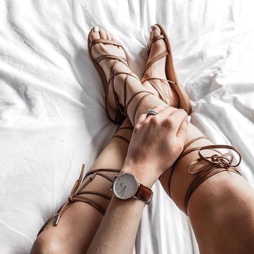 Leather lace up sandals on pretty feet.