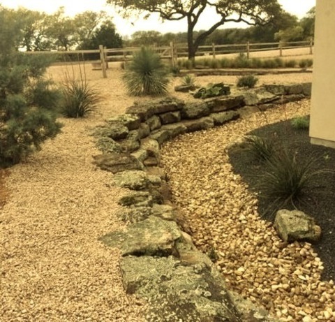 Gravel In AustinPhoto Of A Southwestern Drought-tolerant And Full Sun Hillside Gravel Landscaping.