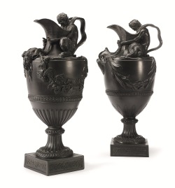 hadrian6:    A pair of Wedgwood black basalt  Wine and Water Ewers. 19th century. each modeled with either a Satyr or Triton representative of Bacchus or Neptune, seated upon the shoulder of the shield-shaped body of the ewer, his arms extending around