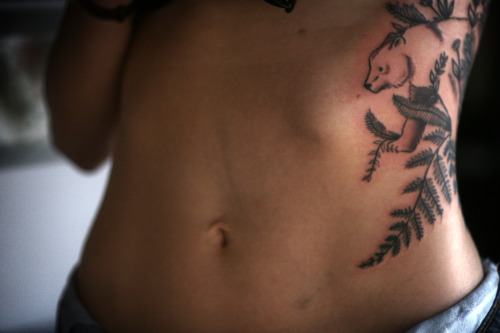 Porn  bear on the ribs with ferns and stylized photos