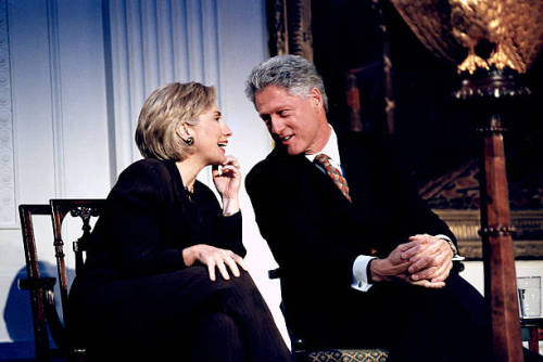 Pres. Bill &amp; Hillary Rodham Clinton exchanging smiles in moment of intimacy while hosting mi