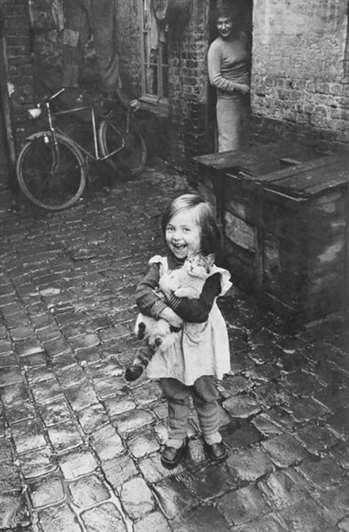 Young French girl showing off her cat