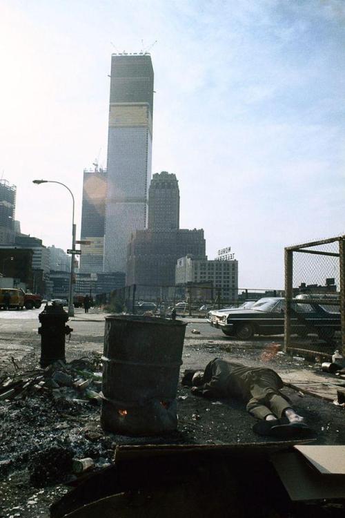 historicaltimes: A homeless man sleeps on the ground near the unfinished World Trade Center in New York City, 1970. via reddit 