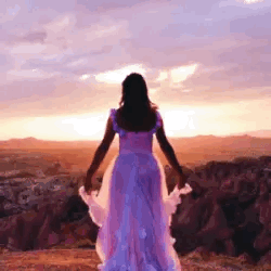 someone in front of a sunset tossing up their flowered skirt