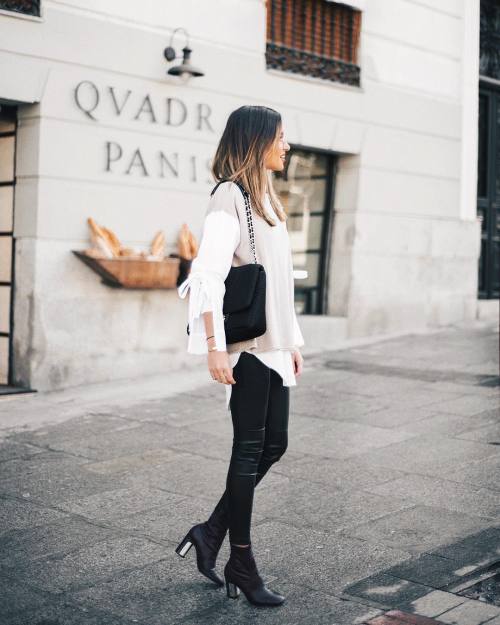 justthedesign: Alba Hervas wears tight leather leggings with sleek black boots, a layered white blou