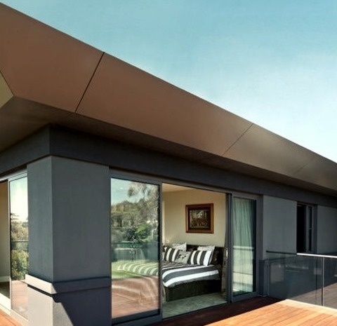 Melbourne Metal Hip Roof On A Large, Minimalist Gray, Two-story Metal Home Image