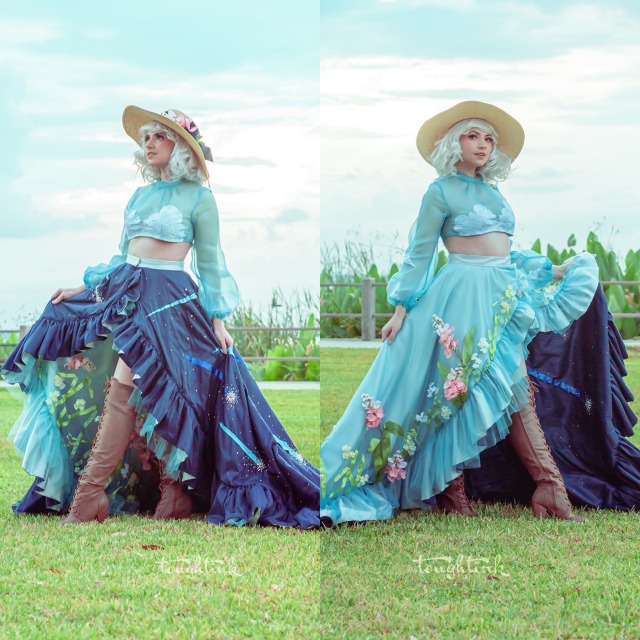 two photos of a woman posing in a howl's moving castle inspired look in a field. the look includes a sky blue blouse with clouds on the bust & sleeves, a hat, and a large wrapped skirt which is dark blue with comets on one side and light blue with flowers on the other side.