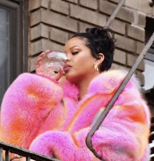 Playful Bella Hadid larks around in a pink fur hat and Louis Vuitton chain  top