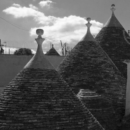 The Cone-shaped Roofs Of Alberobello's Trulli In Puglia, Italy. Derived From The Greek Word Τρούλος