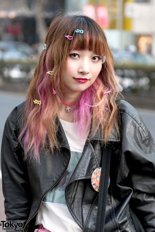 Sakura Pluto on the street in Harajuku wearing a biker jacket over Bubbles tee, ripped pink Candy St