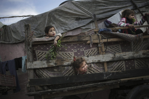 Palestinian refugee children play in a poverty-stricken quarter of the town of Beit Lahiya, northern