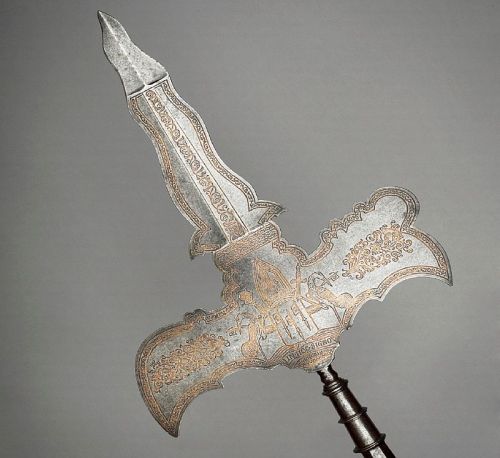 art-of-swords:  Partizans Photo #1 Attributed to Jean Berain I (1640 - 1711) Dated: circa 1670 - 1680 Culture: French Medium: steel, gold and velvet, etched, chiselled and gilded Measurements: blade length: 53.2 cm, straps length: 7.3 cm. Weight: 1.92 kg