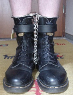 whipman-andy: Set-up for a boot- &amp; work-slave: This is the full set of restraints for the night in his cell. In the morning, only the rigid irons will be removed, so he can do hard work with the chain-cuffs still on. Those only need to go on and