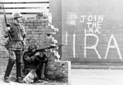 mickinamerica:Not sure when this picture was taken, but looks like the 1970s. In Derry, Ireland, in the Bogside. I love the juxtaposition of the armed British soldiers behind the wall and the giant statement of dissent behind them.