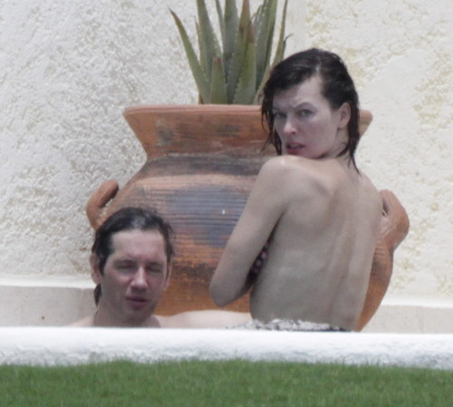 toplessbeachcelebs:  Milla Jovovich (Actress) in a jacuzzi topless in Los Cabos (August 2011)