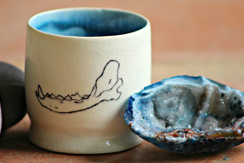 xcatalicious:  This one’s for my tea drinking homies! Wheel thrown porcelain tea cup with human teeth and dog jaw bone hand painted on opposite sides covered in a cracking clear glaze. You can buy it right hurrrr if you want…not trying to force anything,