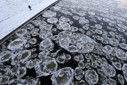 untrustyou:  A pedestrian walked along the banks of the Neris river as temperatures dipped to-0,40 degrees Fahrenheit in Vilnius, Lithuania, Monday Jan 20, 2014. Mindaugas Kulbis/Associated Press 