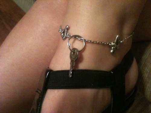 imcagedbywife:  I love the way Mistresses display Their power in different ways. The 7th picture down is my Mistress displaying Her power over me! Mistress always wears it on Her bracelet so anyone can see it and ask about it! Also, I see it, which remind