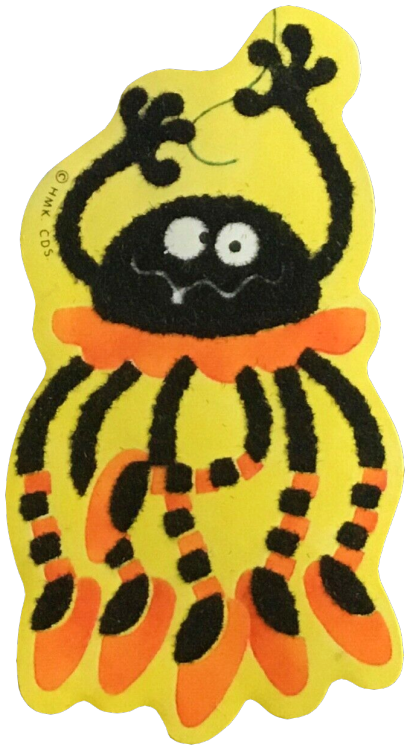 A sticker featuring a black cartoon spider wearing an orange tutu and ballet slippers hanging from a