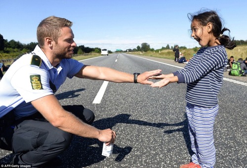emt-monster:  Police officers play with Syrian children at the Danish border  This made my night
