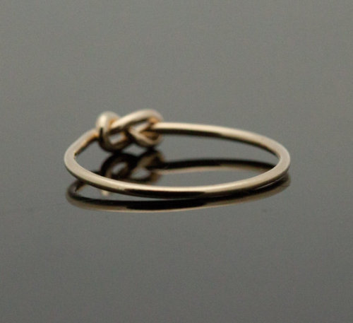 sixpenceee:  A “knot” ring. The ring symbolizes a knot that is not quite tied yet, but has all intentions of being tied. A promise ring.You can purchase one here