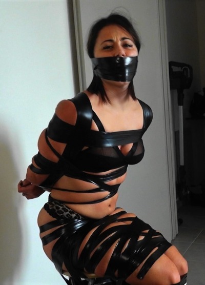 :The thin electrical tape bit into Mia’s flesh and the stuffed tape gag muffled