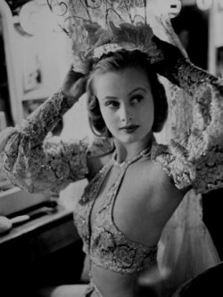 ladiesofburlesque:Chorus Girl Hope Chandler Securing Her Feathered Headdress as She Sits at Makeup Table, Paradise Cabaret, NY, Peter Stackpole, 1937.