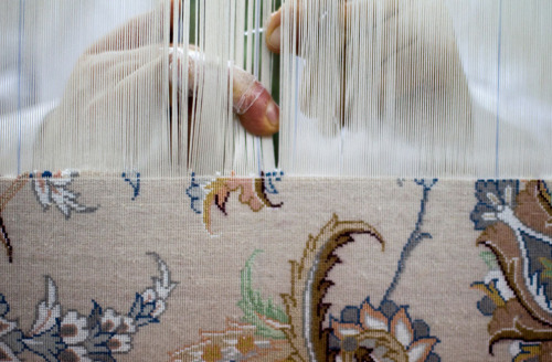 sufiness: A weaver works on a carpet at a carpet workshop in Isfahan, Iran