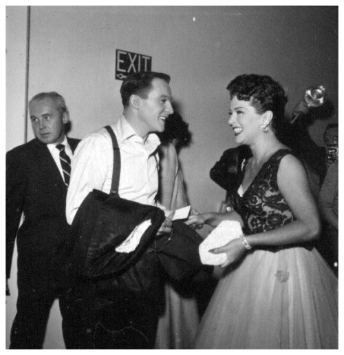 Gene Kelly sharing a laugh with Lana Turner at the 30th Anniversary party for MGM (1954).