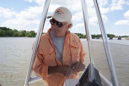 Kevin Rutley on a boat on the Barataria Waterway. (Virginia Hanusik for Here &amp; Now) A Refrain A