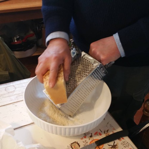 Arnie grates cheese the old fashioned way. Because he has to. We don&rsquo;t have any electric g