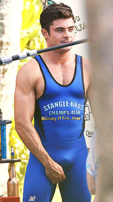 Zac Efron bulges in a wrestling singlet for