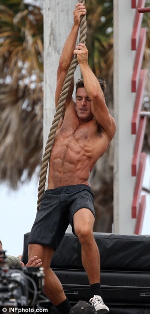 XXX   Baywatch hunk Zac Efron flies through the photo