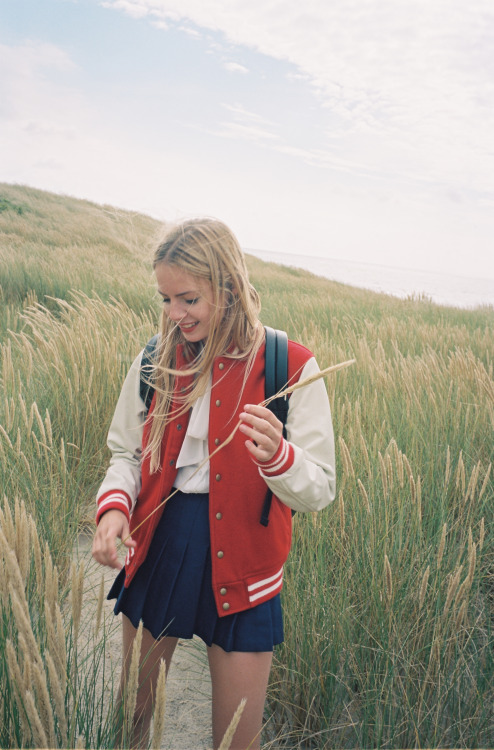 americanapparel:  Mathilde in the Club Jacket, Tennis Skirt & Shiny School Bag.