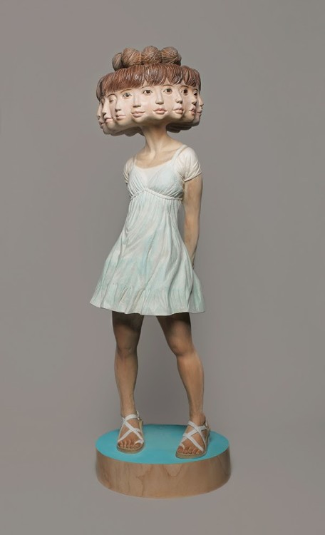 sixpenceee:  The bizarre art of Yoshitoshi Kanemaki. He chisels these life-sized figurative sculptures out of giant pieces of camphor wood, a kind of evergreen. The strange pieces frequently involve two or more characters merged into a single form, which