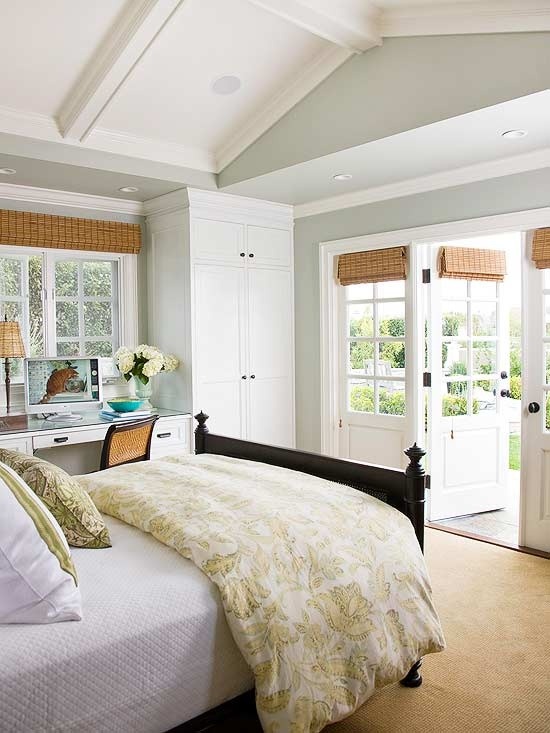 Multi-functional master. A place to sleep, a place to work, and a place to enjoy the outdoors. Love the woven window shades, and a gray and white color scheme makes the room feel breezy.