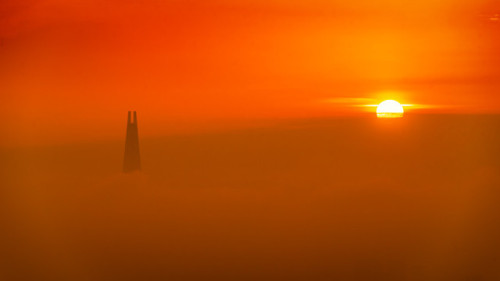 Top of Lotte Tower peaks out from above the clouds at sunrise.