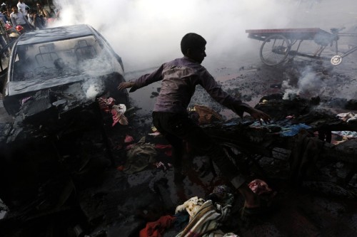 untrustyou: A boy tried to control a fire after cars were torched during clashes between Bangladesh’