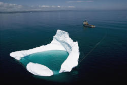 happinessache:  visitheworld:  Ship towing an iceberg off the shore of Newfoundland / Canada (via theamazingpics),  ع