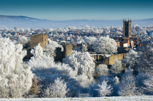 A snowy view of the town of Ludlow with the medieval castle in the foreground.