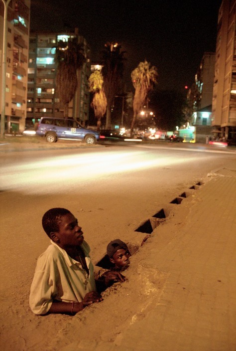 unrar: Street Children in Luanda, Angola. Street kids come out from the sewer to the street at night