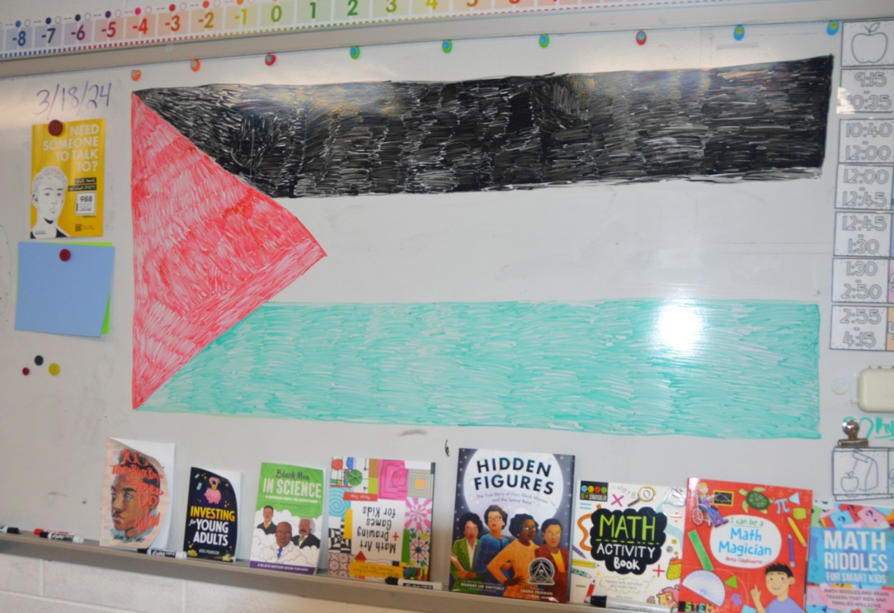 A photo of a classroom whiteboard. The Palestinian flag has been drawn on the whiteboard with markers.