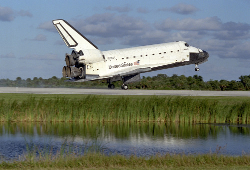 The Space Shuttle orbiter Atlantis touches down on Runway 15 of the Kennedy Space Center Shuttle Landing Facility (SLF) at the conclusion of the nearly 11-day STS-86 mission. Main gear touchdown was at 5:55:09 p.m. EDT, October 6, 1997, with an...